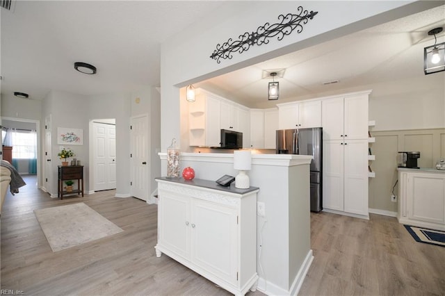 kitchen with light hardwood / wood-style floors, stainless steel fridge with ice dispenser, kitchen peninsula, and white cabinets