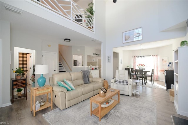 living room featuring wood-type flooring and a high ceiling