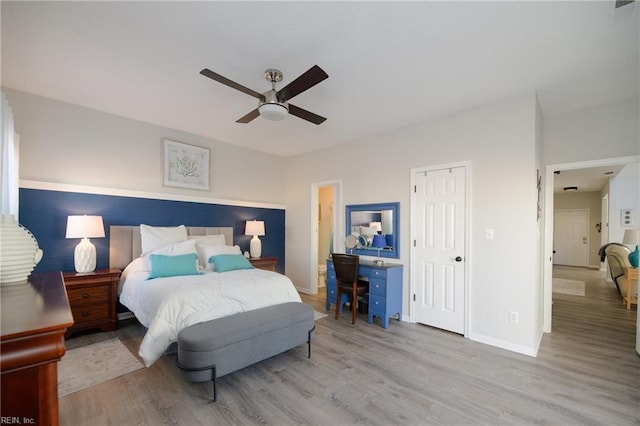 bedroom with light hardwood / wood-style flooring and ceiling fan