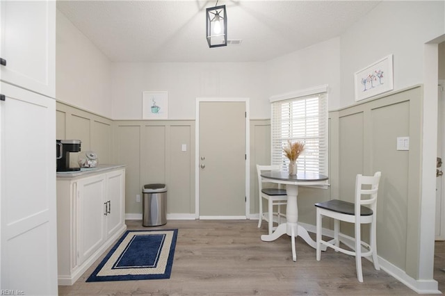 interior space featuring light hardwood / wood-style floors and white cabinets