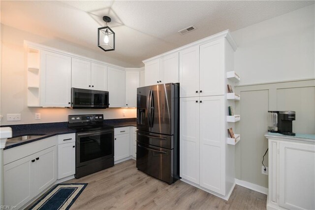 kitchen featuring sink, light hardwood / wood-style floors, white cabinets, and appliances with stainless steel finishes