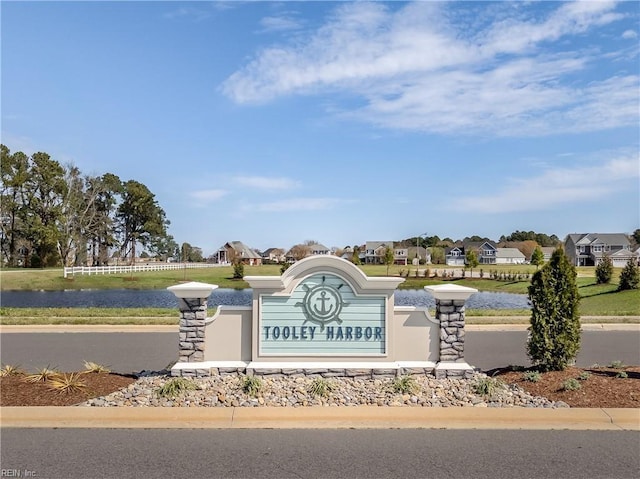 community sign featuring a water view