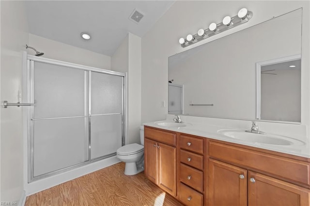 bathroom with vanity, hardwood / wood-style floors, toilet, and walk in shower