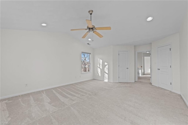 unfurnished room featuring lofted ceiling, light colored carpet, and ceiling fan