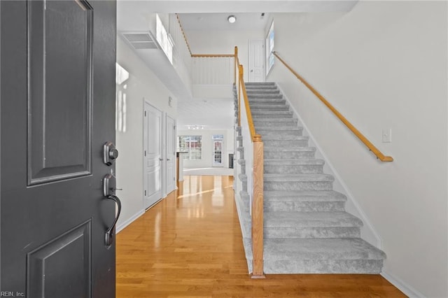 entryway featuring a high ceiling and hardwood / wood-style floors