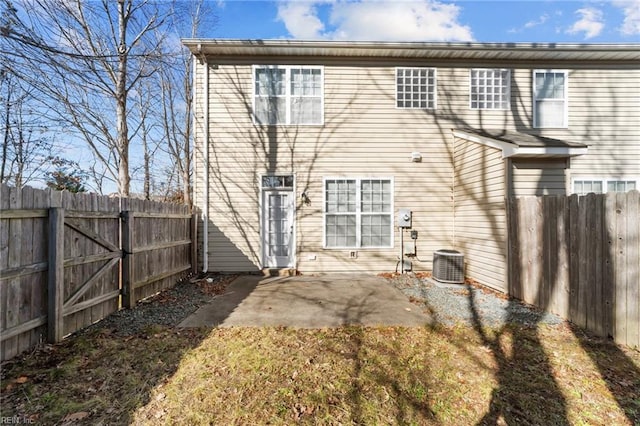 back of property with cooling unit and a patio area