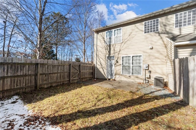 rear view of property featuring central AC, a patio area, and a lawn