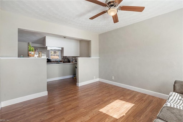 unfurnished living room with hardwood / wood-style flooring and ceiling fan