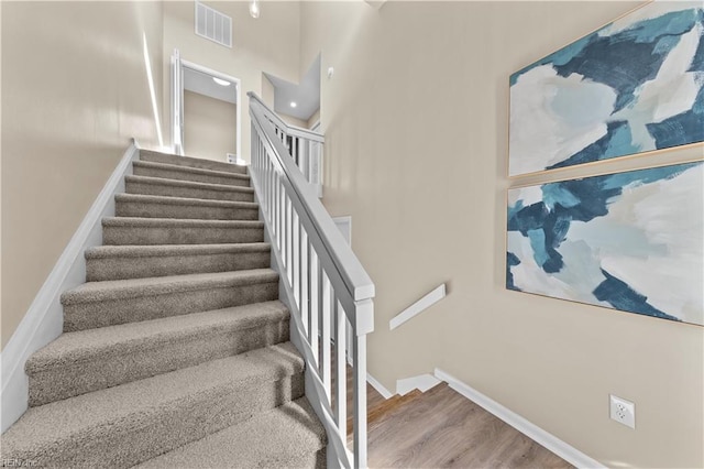 stairway with hardwood / wood-style floors