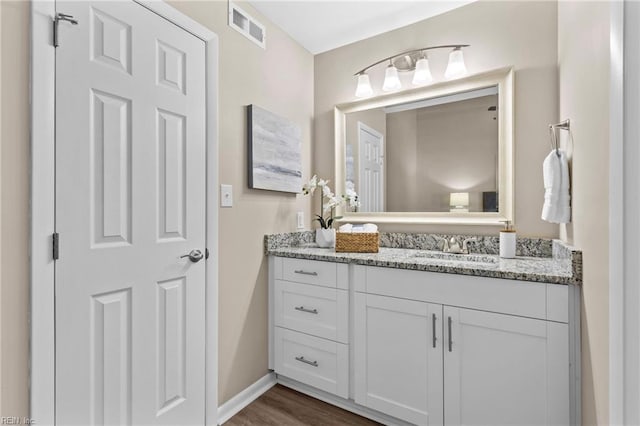 bathroom featuring vanity and wood-type flooring