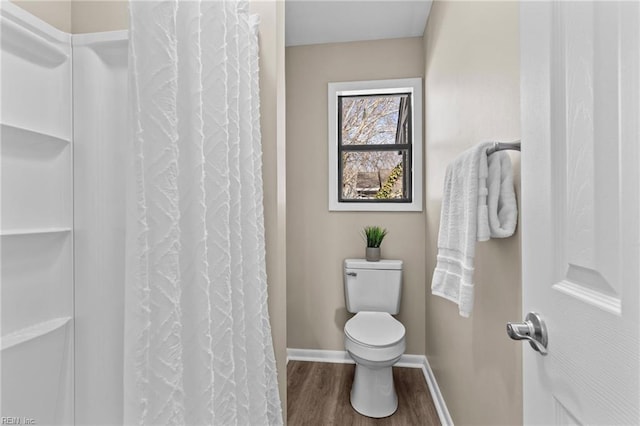 bathroom with toilet, hardwood / wood-style floors, and walk in shower