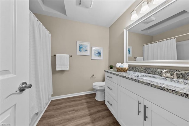 bathroom with vanity, toilet, and hardwood / wood-style floors