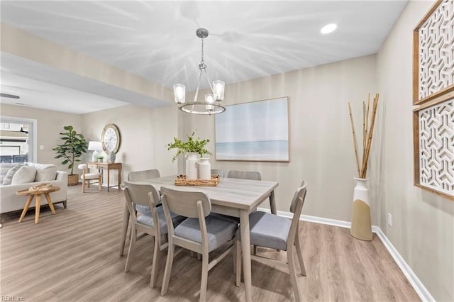 dining room with an inviting chandelier and light wood-type flooring