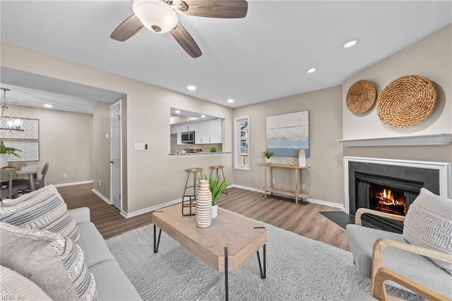 living room with hardwood / wood-style floors and ceiling fan