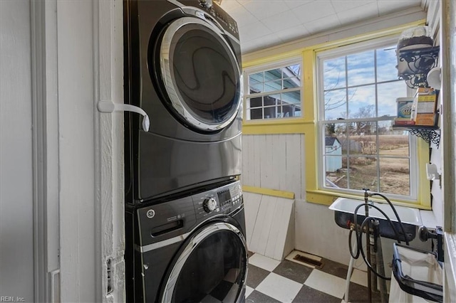 laundry area with stacked washer / drying machine