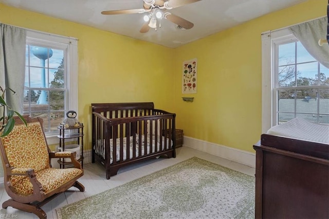 bedroom featuring light tile patterned floors and ceiling fan