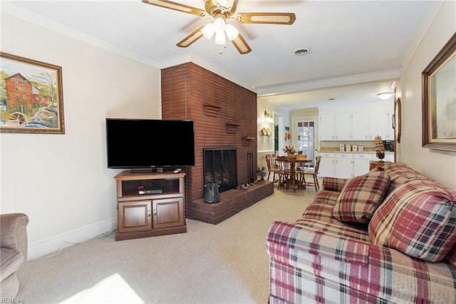 carpeted living room with a fireplace, ornamental molding, and ceiling fan