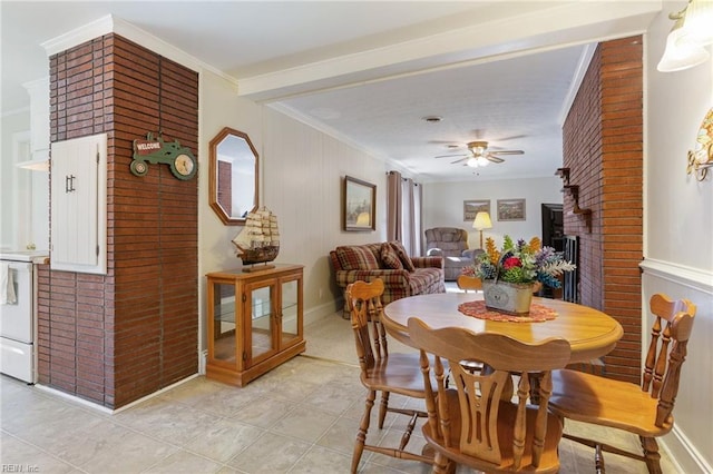 dining room with crown molding, ceiling fan, and light tile patterned floors