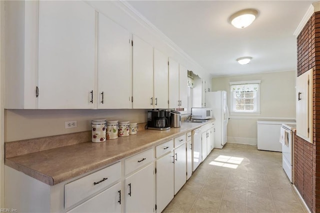 kitchen featuring white cabinetry, ornamental molding, and white appliances