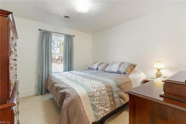 bedroom featuring light colored carpet