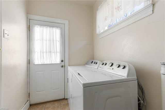 washroom with separate washer and dryer and light tile patterned floors