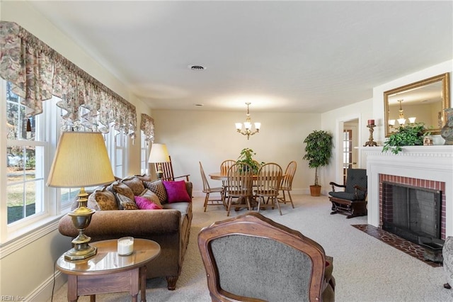 living room featuring an inviting chandelier, a fireplace, and light colored carpet