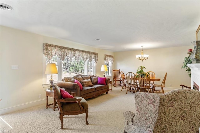 carpeted living room with a notable chandelier