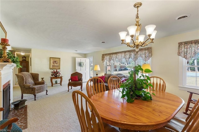 dining space featuring a chandelier and carpet flooring