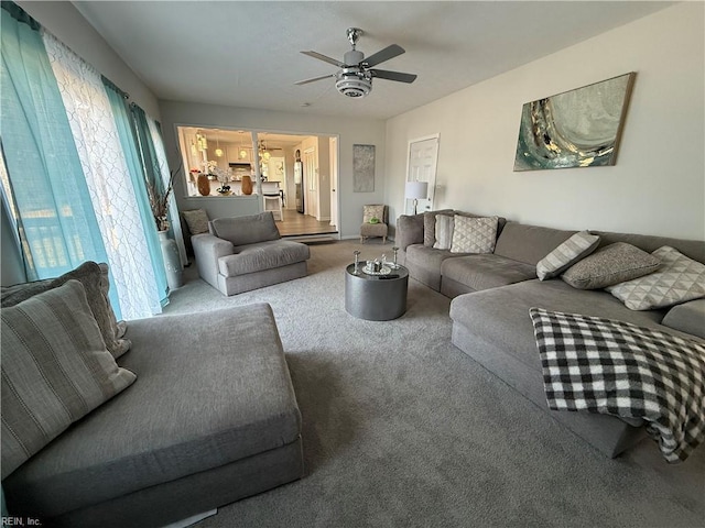 carpeted living room featuring ceiling fan