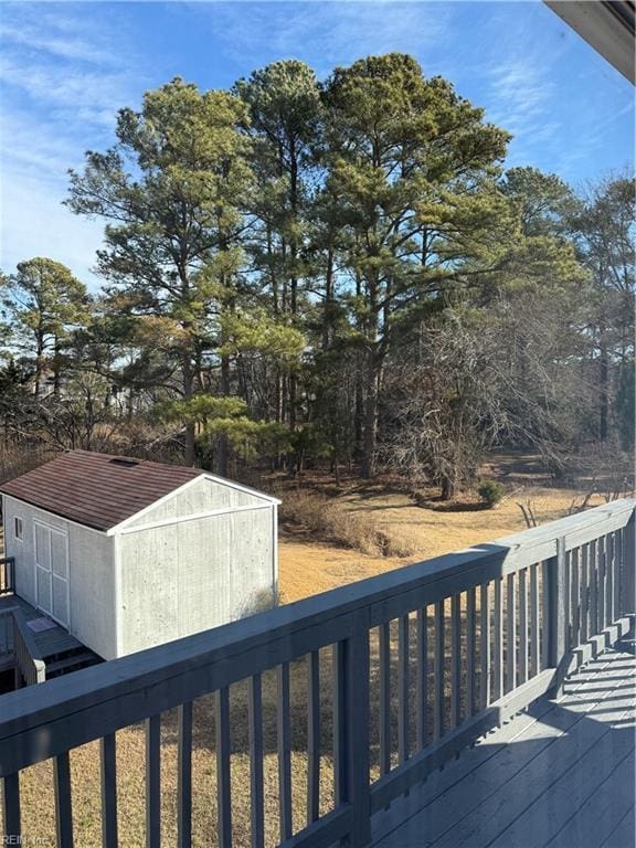 wooden terrace with a storage shed