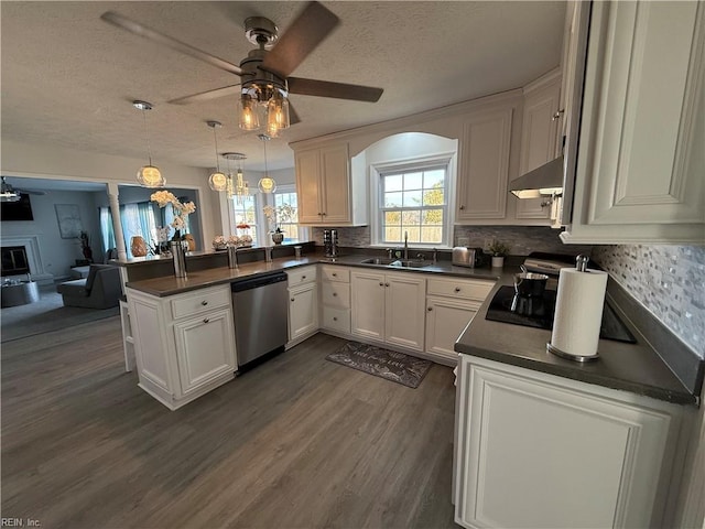 kitchen with pendant lighting, range hood, white cabinetry, stainless steel dishwasher, and kitchen peninsula