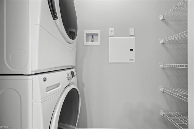 clothes washing area with stacked washer / drying machine