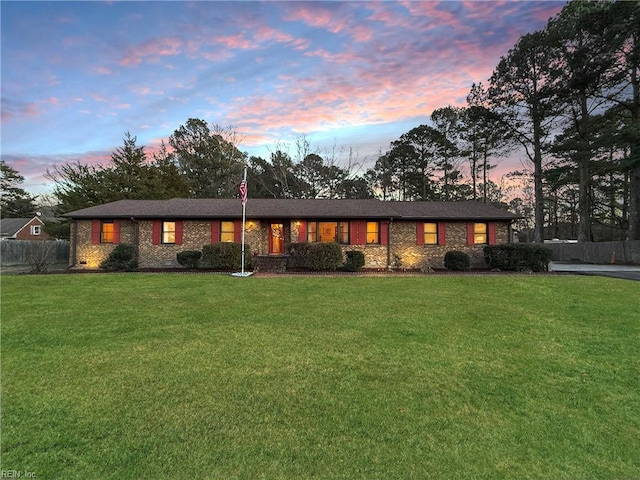 ranch-style house featuring a lawn