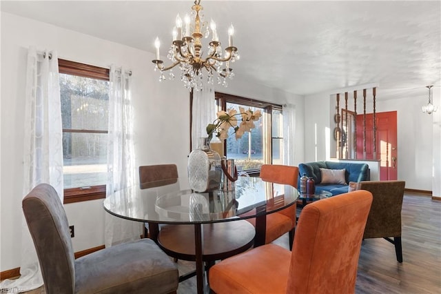 dining room featuring an inviting chandelier and dark wood-type flooring