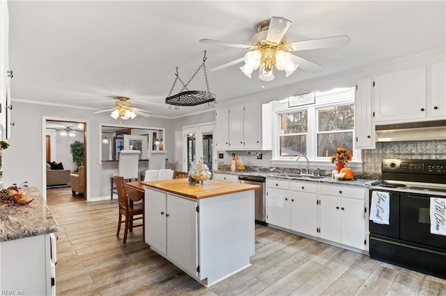 kitchen featuring white cabinetry, black range with electric stovetop, a kitchen island, and stainless steel dishwasher