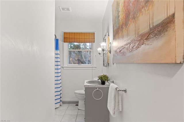 bathroom featuring vanity, tile patterned floors, and toilet