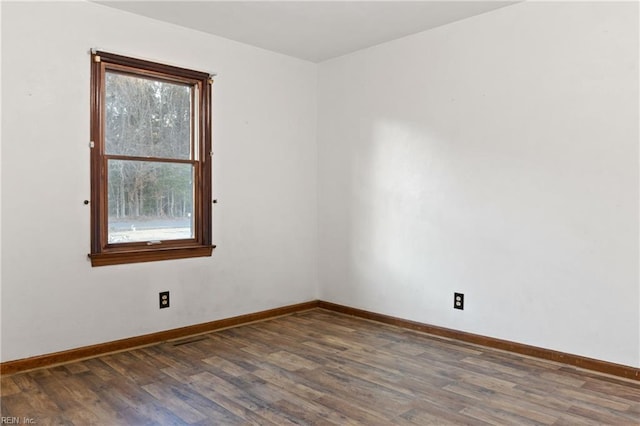 empty room with dark hardwood / wood-style flooring