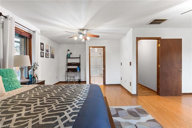 bedroom featuring ceiling fan, ensuite bathroom, and light wood-type flooring