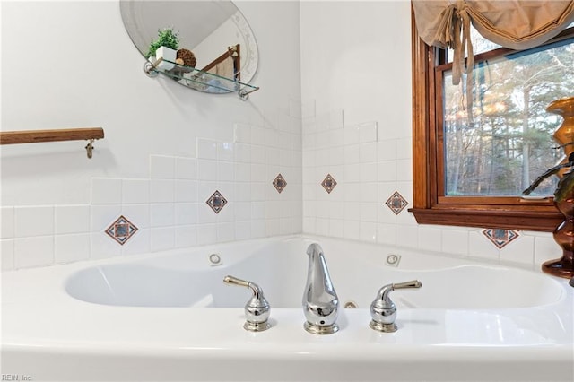 bathroom featuring tiled tub