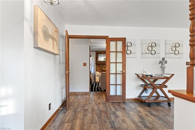 hallway with hardwood / wood-style flooring and french doors