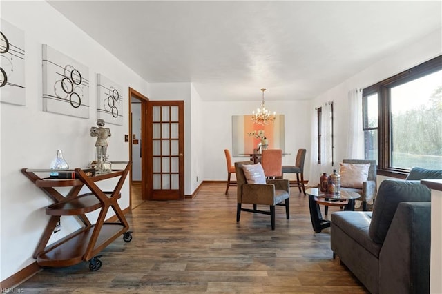 dining space featuring dark wood-type flooring and an inviting chandelier