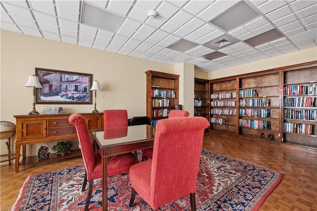 dining area featuring parquet flooring