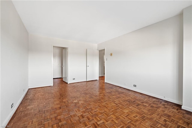 empty room with dark parquet flooring