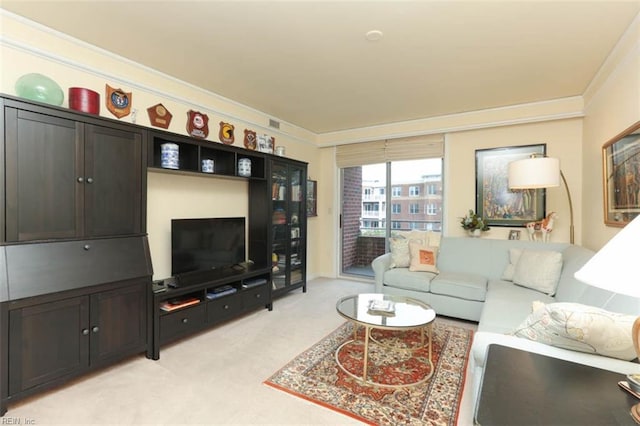 carpeted living room with ornamental molding