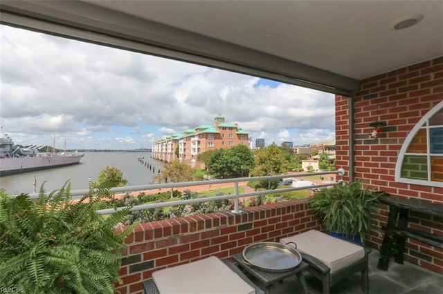 balcony featuring a water view