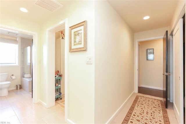 hallway featuring light tile patterned floors