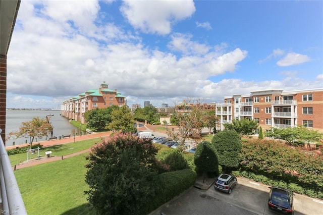 surrounding community featuring a water view and a yard