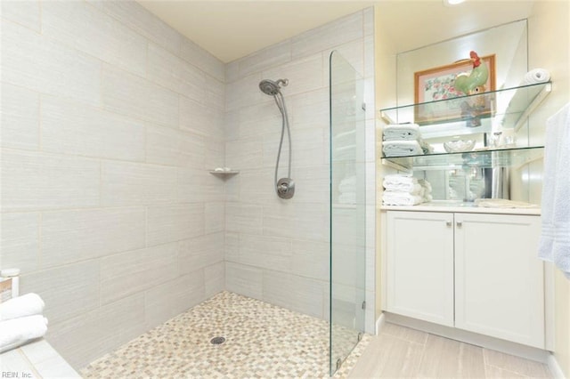 bathroom featuring vanity and tiled shower