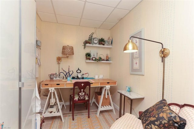 office area with a paneled ceiling