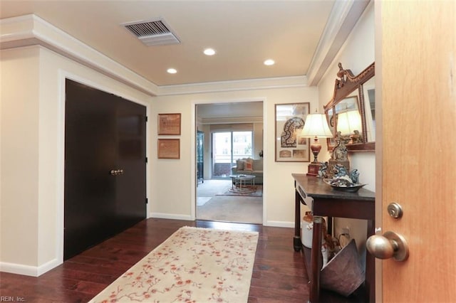 entryway featuring ornamental molding and dark hardwood / wood-style floors